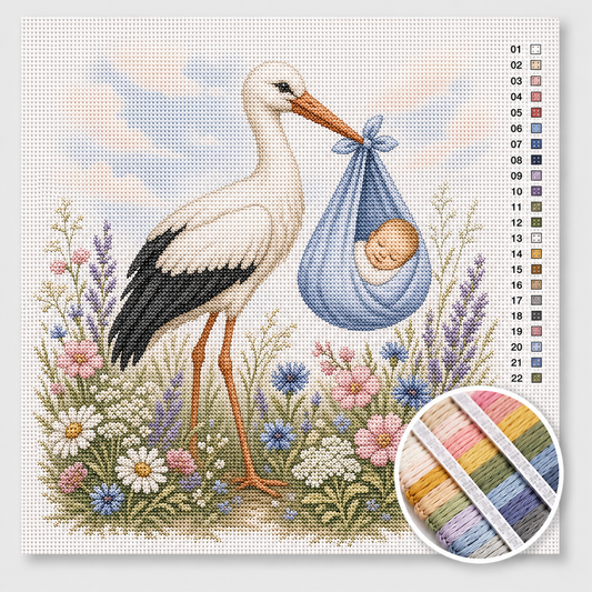 Ooievaar met babyjongen kruissteek pakket — witte ooievaar met blauwe wikkeldoek tussen wilde bloemen